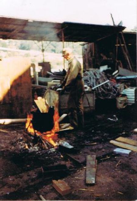Here is Bill  with a good fire heating up a pot of lead, then pouring it into moulds, 1983
